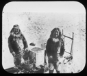 Image of Two Inuit men by sledge. Containers